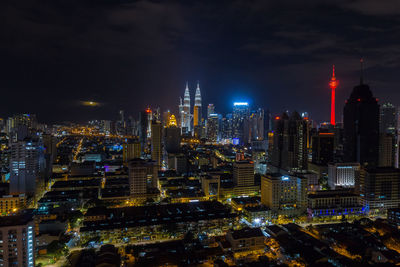 Illuminated cityscape against sky at night