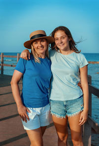 Portrait of young woman standing at beach