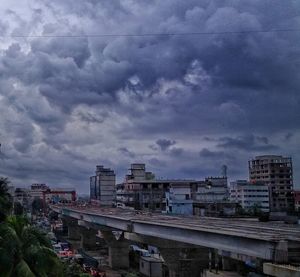 Buildings in city against cloudy sky