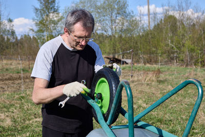 Side view of young man working on field