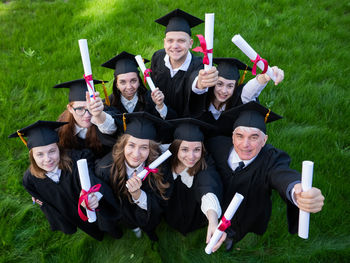 Portrait of students standing on field