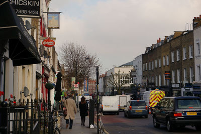 Vehicles on road against buildings in city