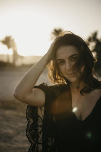 Portrait of woman standing against sky