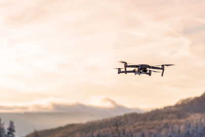 Drone flying at dusk in sunset.