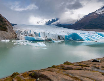 Global warming - transformation of a glacier into a pool of water. impact of rising temperatures.