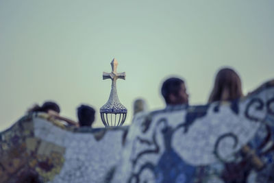 Low angle view of cross against building