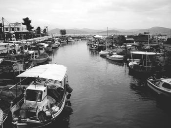High angle view of boats moored at harbor against sky