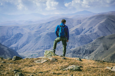 Rear view of man standing on mountain