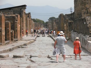 Group of people walking along ruined structures