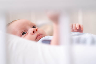 Close-up of baby boy sleeping on bed