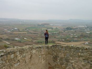 Full length of woman standing on rock