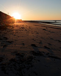 Scenic view of beach against sky during sunset