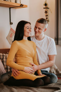 Young couple sitting at home