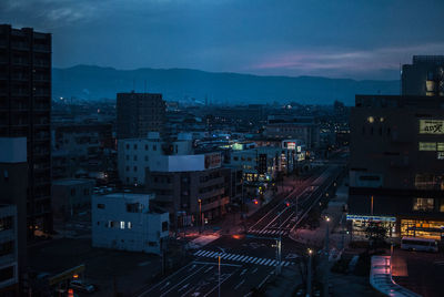 High angle view of illuminated buildings in city at night