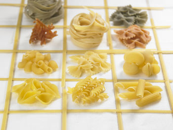 High angle view of various pastas on fabric