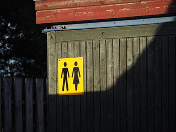 Close-up of information sign on wall