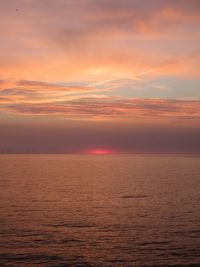 Scenic view of sea against romantic sky at sunset
