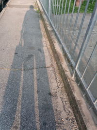 High angle view of shadow of person on road
