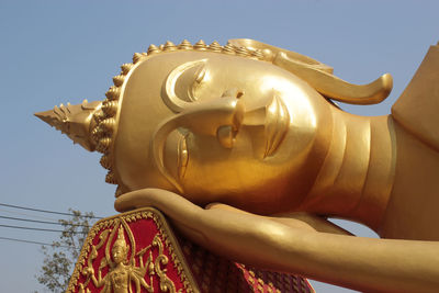 Low angle view of statue against building against sky