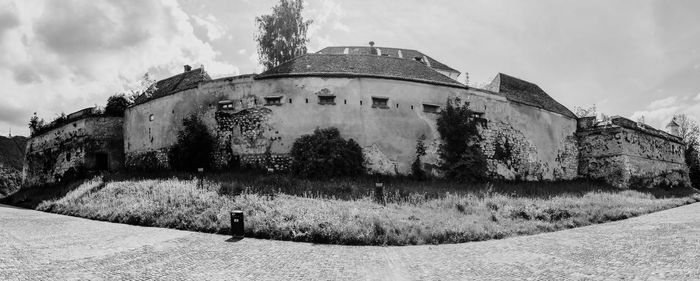 Old building on field against sky