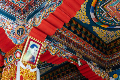 Low angle view of ornate ceiling in temple building