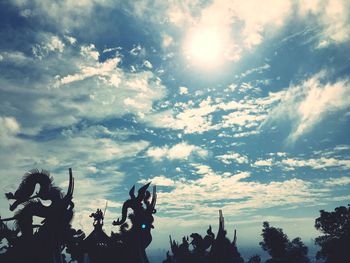 Low angle view of silhouette trees against sky