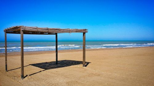 Built structure at beach against clear sky