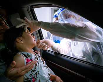 High angle view of mother and daughter in car