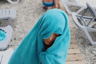 High angle view of boy sitting outdoors