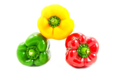 Close-up of red bell peppers against white background