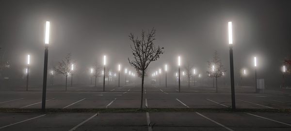 View of illuminated street lights at night