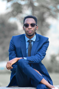 Portrait of young man wearing sunglasses standing outdoors