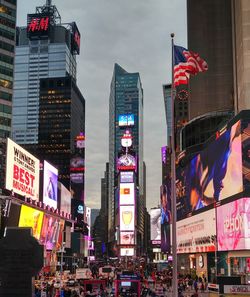 Illuminated buildings in city against sky