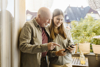 Side view of young woman using mobile phone