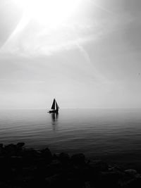 Scenic view of sailboat in sea against sky