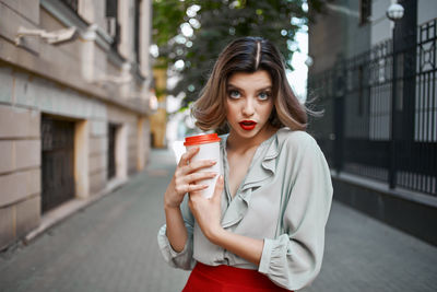 Beautiful young woman drinking water