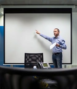 Full length of man standing in office