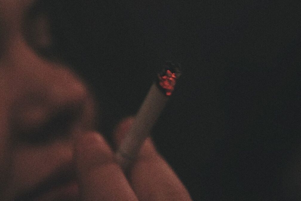 CLOSE-UP OF WOMAN HAND ON BLACK BACKGROUND