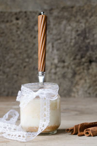 Close-up of drink on table against wall