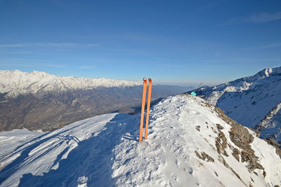 Scenic view of snowcapped mountains against blue sky