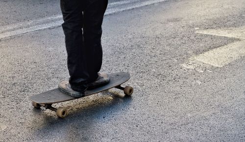 Low section of man standing on road