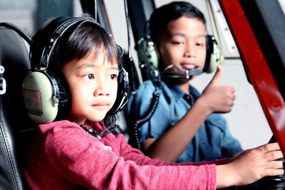 Siblings sitting in helicopter