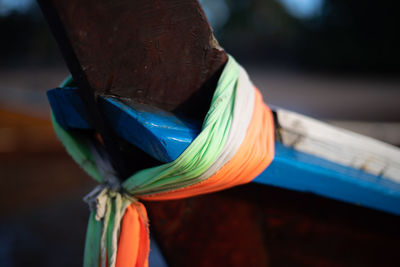 Close-up of blue tied to wood
