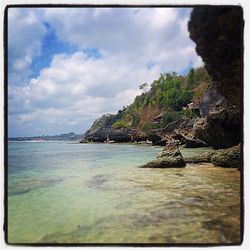 Scenic view of sea against cloudy sky