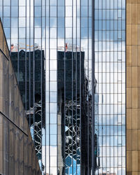 Low angle view of modern glass building in city