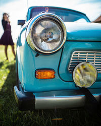 Close-up of vintage car on field