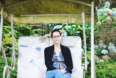 Portrait of young woman sitting outdoors