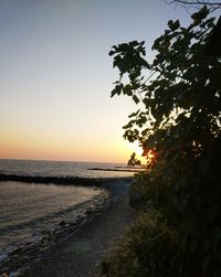 Scenic view of sea against clear sky at sunset