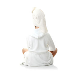 Rear view of woman sitting against white background