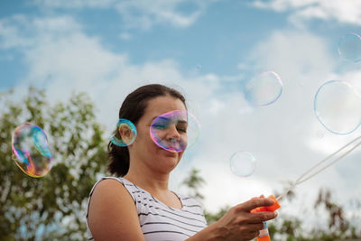 Portrait of mature man holding bubbles